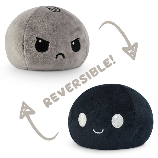 A TeeTurtle Reversible Ball Plushie (Gray + Black) with the words 