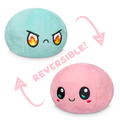Two reversible plush toys, one being a TeeTurtle Reversible Ball Plushie (Aqua + Pink) and the other featuring the brand TeeTurtle.
