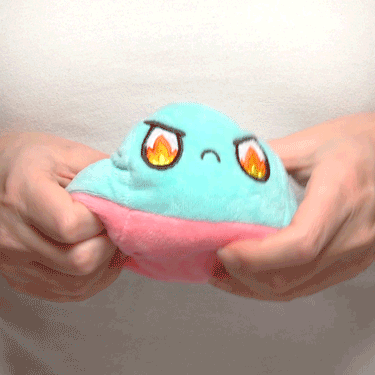 A person holding a TeeTurtle Reversible Ball Plushie (Aqua + Pink) pokemon plush toy from TeeTurtle.