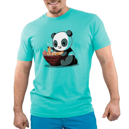 A person wearing a Caribbean Blue T-shirt with a printed design of Ramen Panda by monsterdigital, holding a bowl of steaming noodles. The shirt is made from Super Soft Ringspun Cotton. The person's head and lower body are cropped out of the image.
