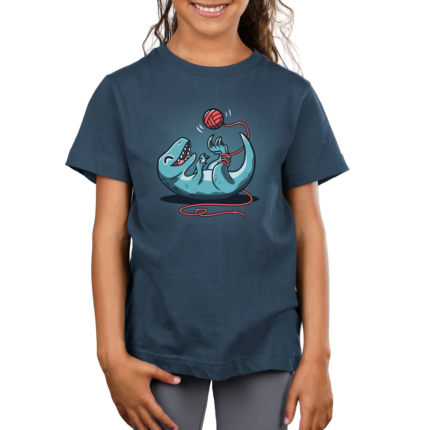 A girl wearing a TeeTurtle Velocikitty T-shirt with an image of a shark.