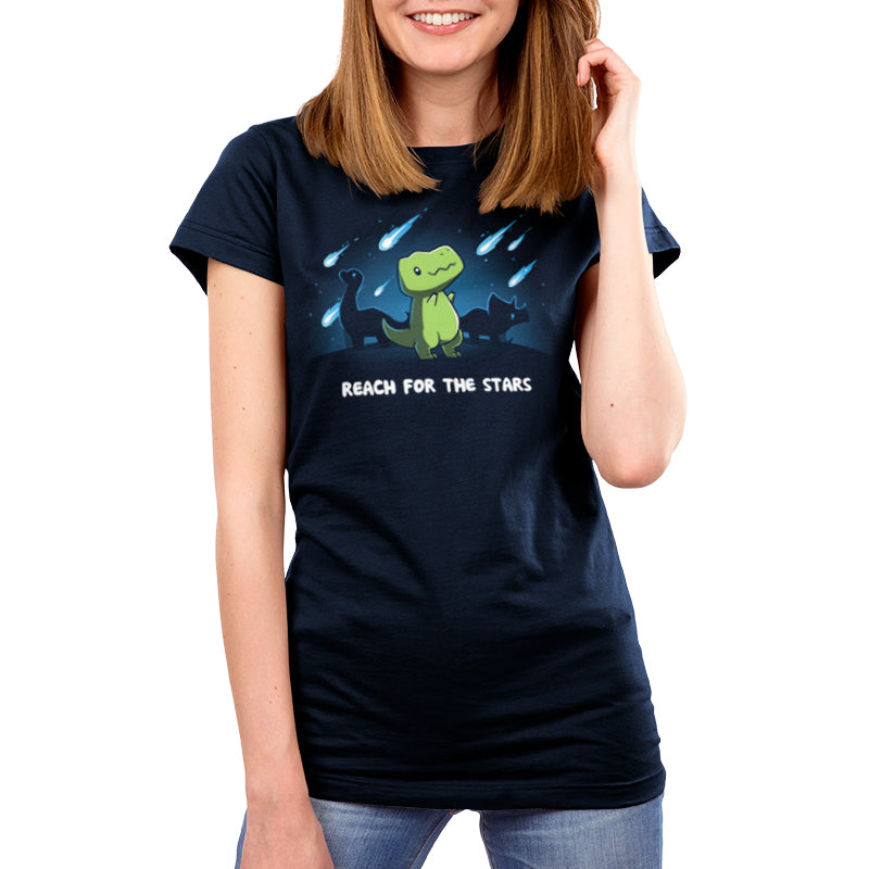 A woman wearing a Reach For The Stars (T-Rex) t-shirt from TeeTurtle.