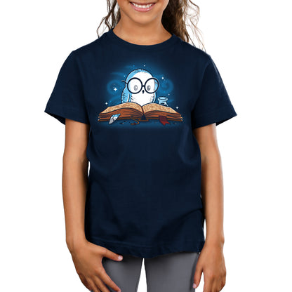 A girl wearing a navy blue TeeTurtle original "Reading is Magical" t-shirt with an image of an owl reading a book.