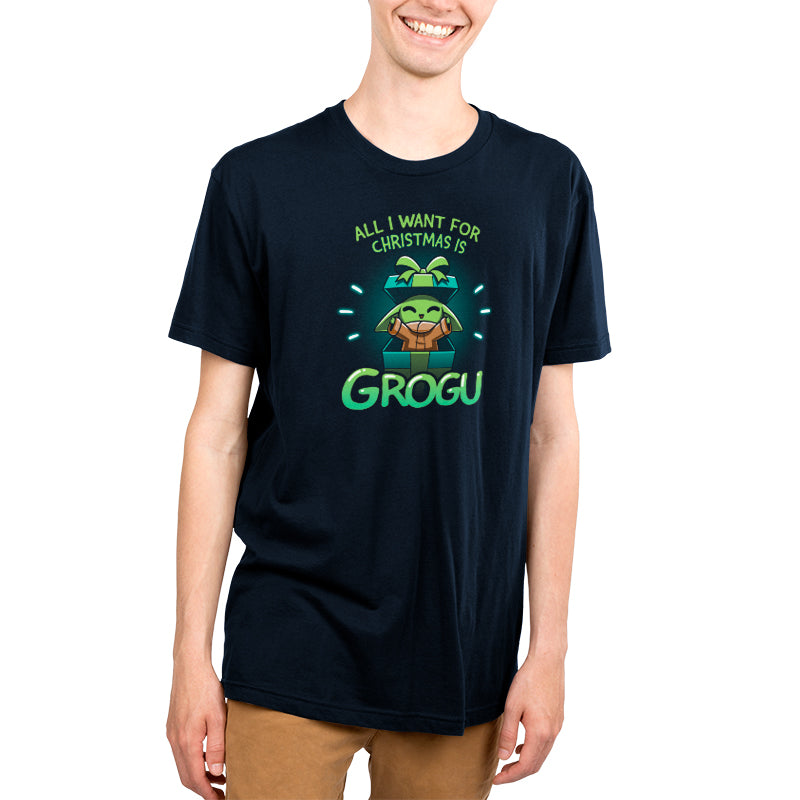 A young man wearing an officially licensed Star Wars T-shirt with the adorable "All I Want For Christmas Is Grogu" printed on it.