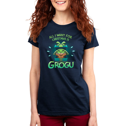 A woman wearing an officially licensed Star Wars T-shirt with "All I Want For Christmas Is Grogu" printed on it.