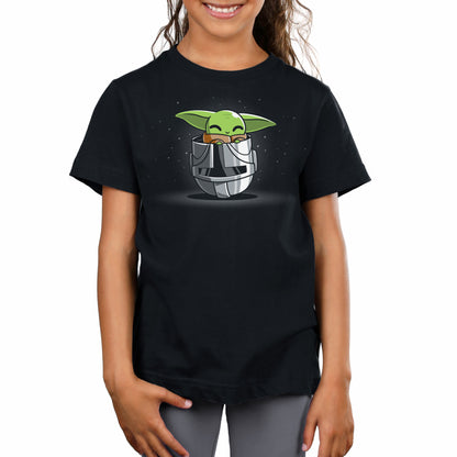 A girl wearing an officially licensed Star Wars Helmet Playtime T-shirt with Grogu, also known as baby yoda, on it.