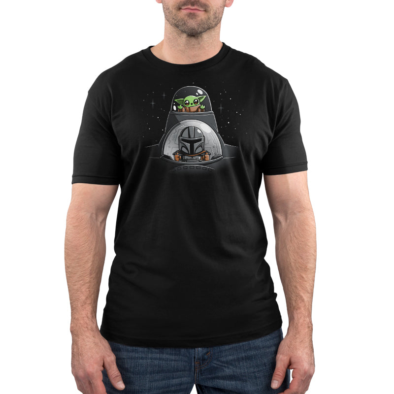 A soft cotton black t-shirt featuring an image of Mando and Grogu's N-1 Adventure in space, from the brand Star Wars.