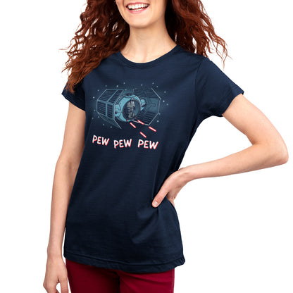 A woman smiling wearing a blue shirt with red hair while holding the Pew Pew Darth Vader from Star Wars.