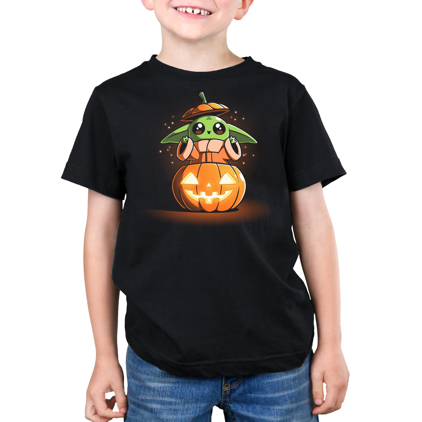 A young boy wearing an officially licensed black t-shirt with Pumpkin Grogu on it from Star Wars: The Mandalorian.
