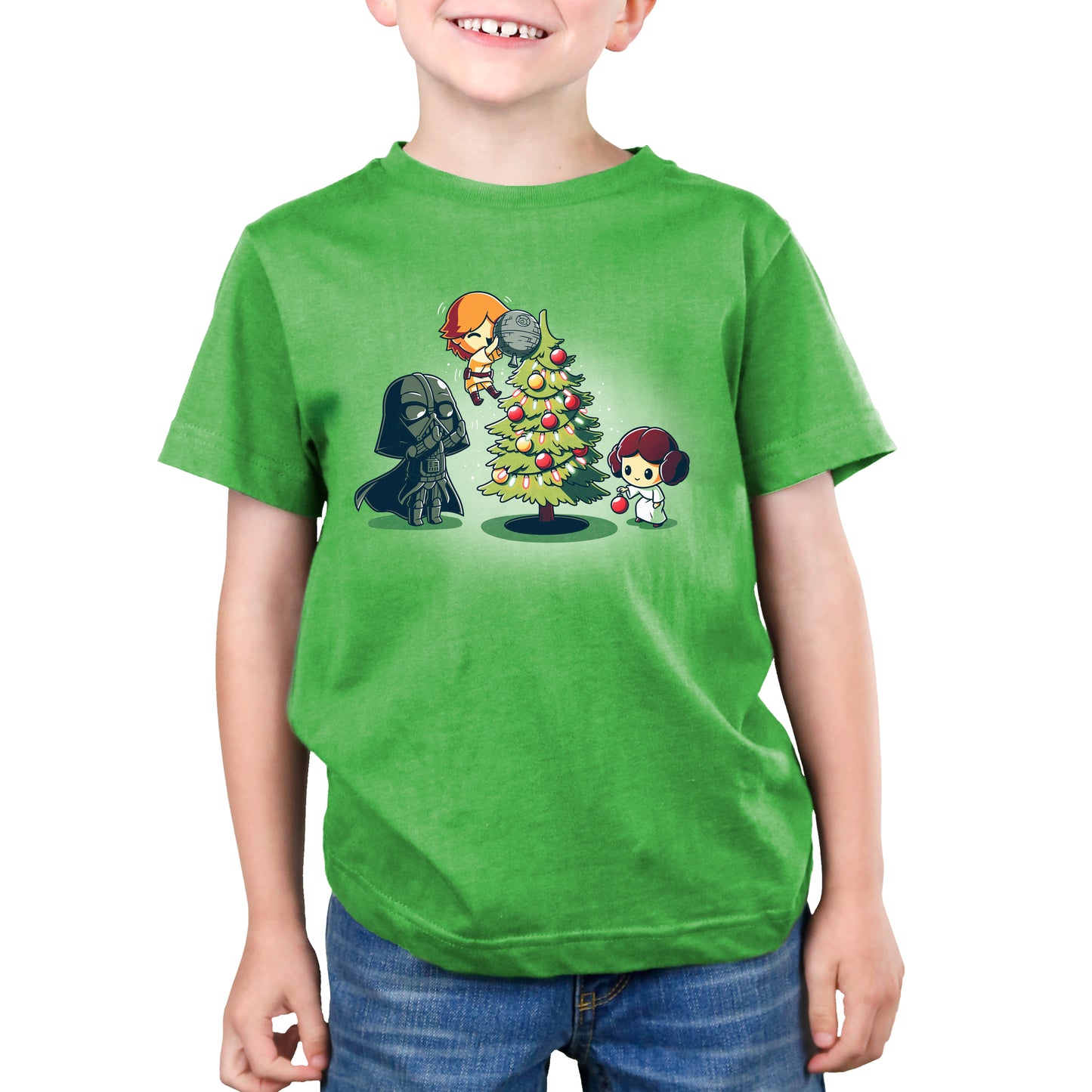 A young boy wearing an officially licensed Star Wars Skywalker Family Christmas t-shirt with a Star Wars Christmas tree.