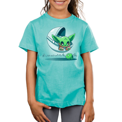 A girl wearing a teal Star Wars Snack Hunting T-shirt.