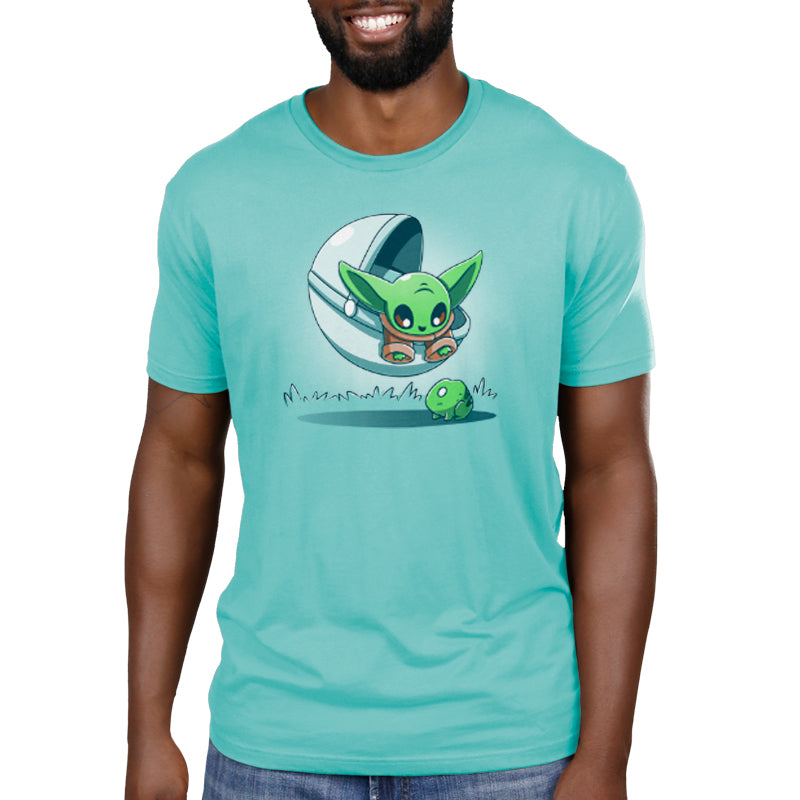 A man wearing a Snack Hunting men's T-shirt featuring an image of Grogu, also known as baby Yoda, by Star Wars.