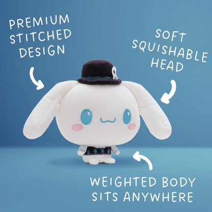A Cinnamoroll Cloudheads plushie with long floppy ears, blue eyes, pink cheeks, and a small dark top hat with a skull detail, shown on a blue background with the text "premium stitched design," "soft squishable head" and "weighted body sits anywhere."