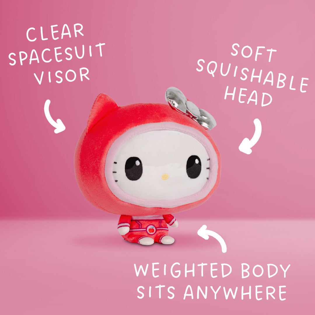 Front view of a Hello Kitty plush wearing a red spacesuit with a red cat-ear hood, silver bow, and small red boots.