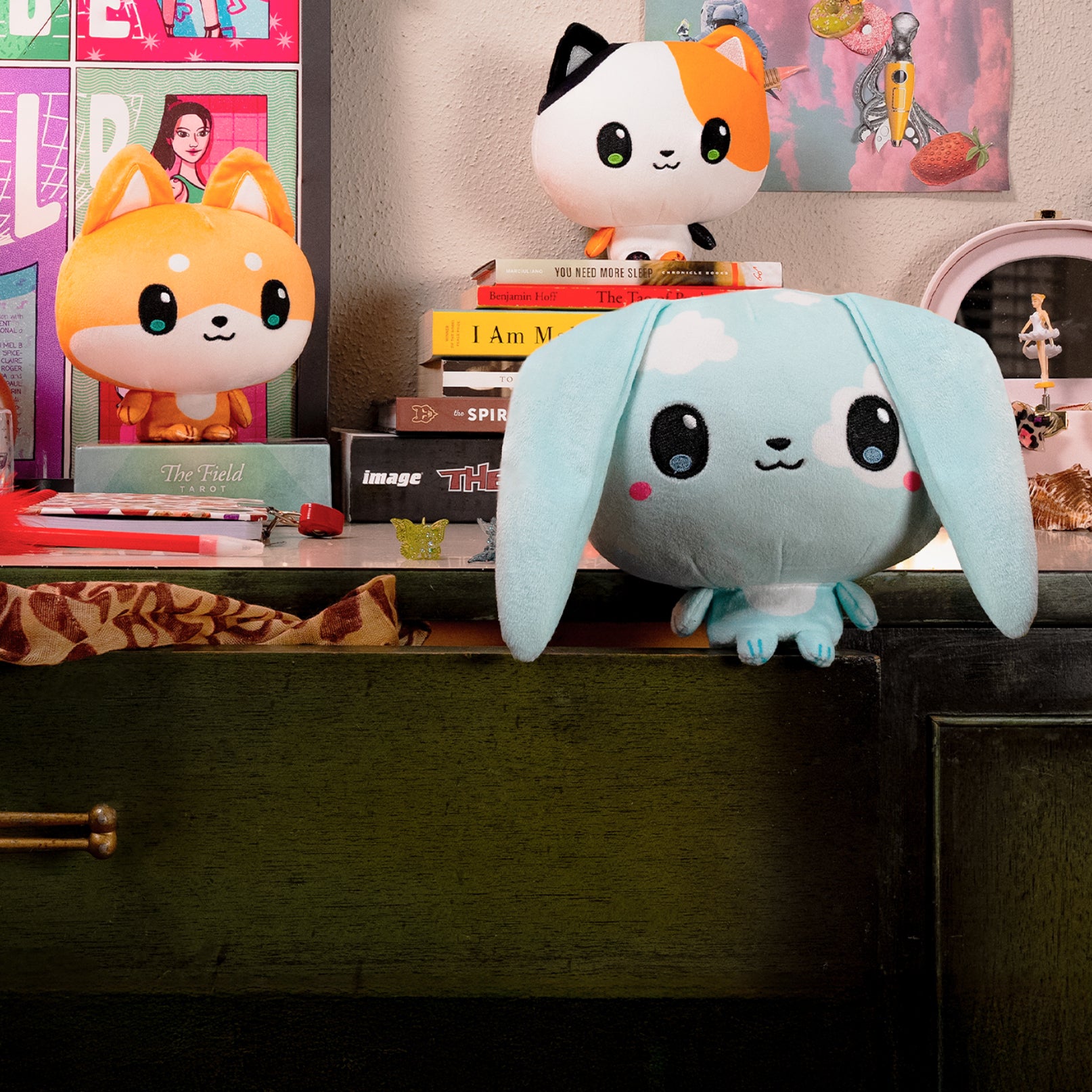 Cloudheads: 5" Shiba Inu (Miso), Cloudheads: 5" Cloud Bunny (Nimbus), and Cloudheads: 5" Calico Cat (Honeybean) sitting on a dresser with books, figurines, and assorted trinkets