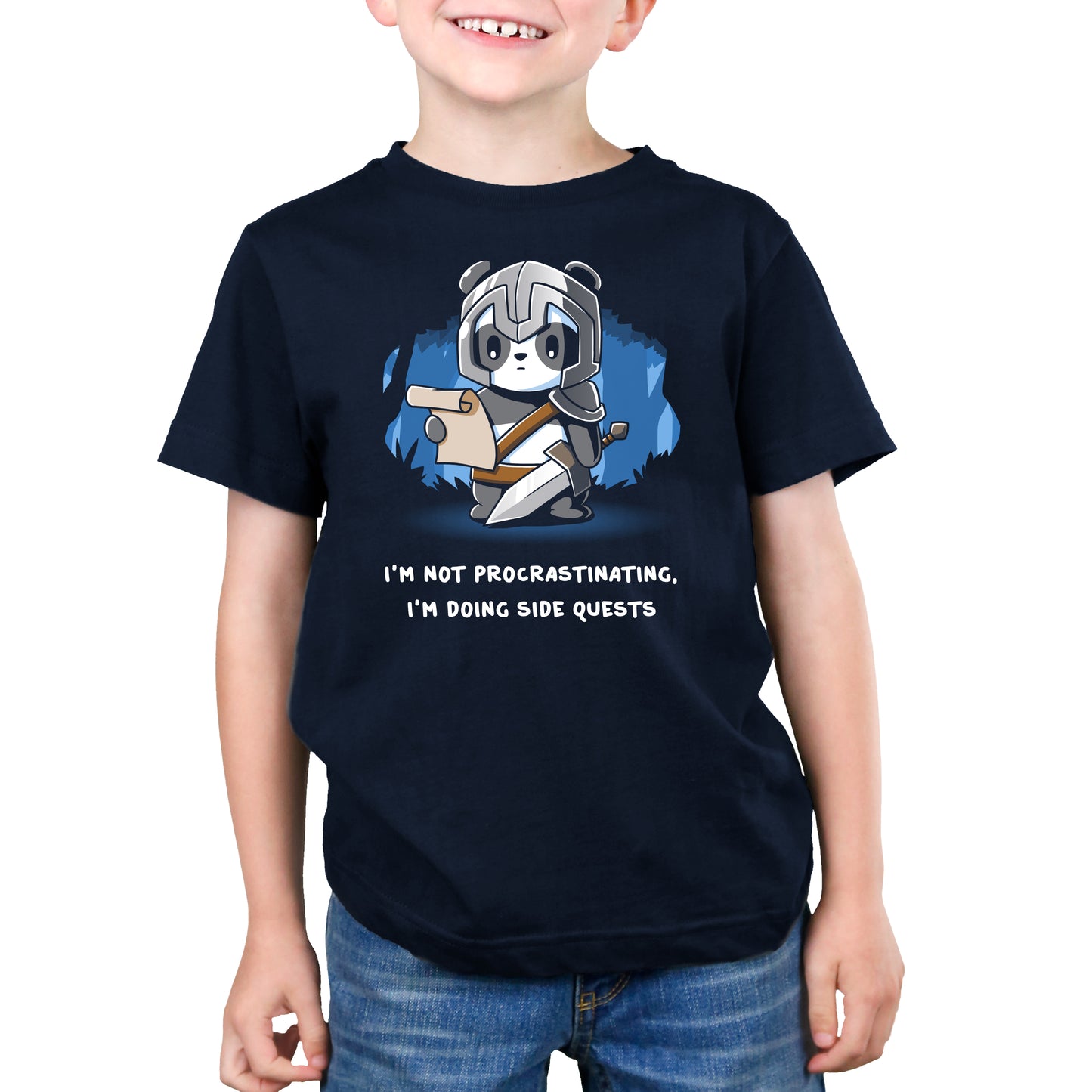 A young boy wearing a navy blue t-shirt that says, "I'm not a politician, I'm a TeeTurtle original" is now wearing a TeeTurtle "I'm Doing Side Quests" t-shirt.