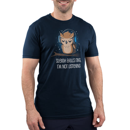 A super soft owl wearing a navy blue t-shirt from TeeTurtle that says "Sleigh Bells Ring, I'm Not Listening.