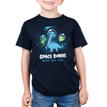 A young boy wearing a navy blue TeeTurtle Space Dinos t-shirt.