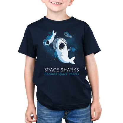 A young boy wearing a Navy Blue Tee with the brand TeeTurtle's product, Space Sharks.
