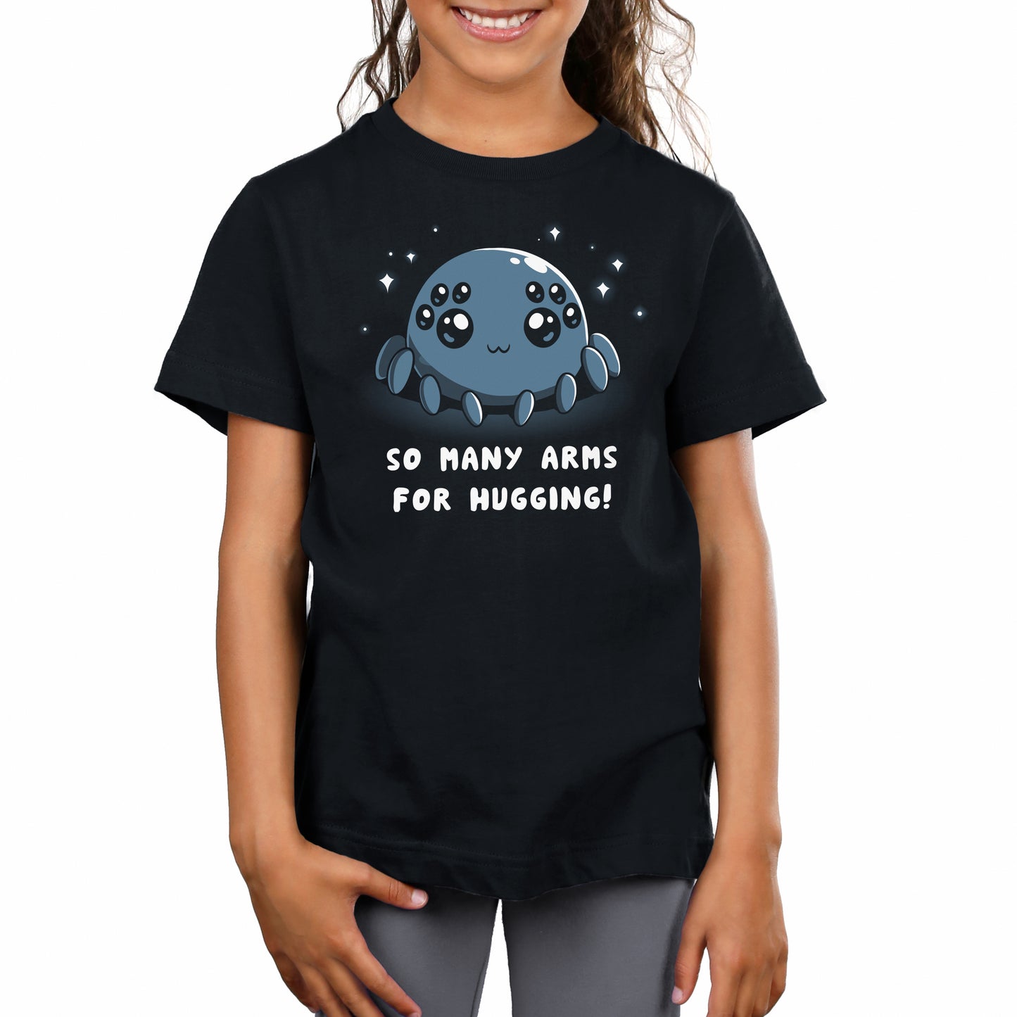 A girl wearing a black t-shirt that says "TeeTurtle Spider Hugs.