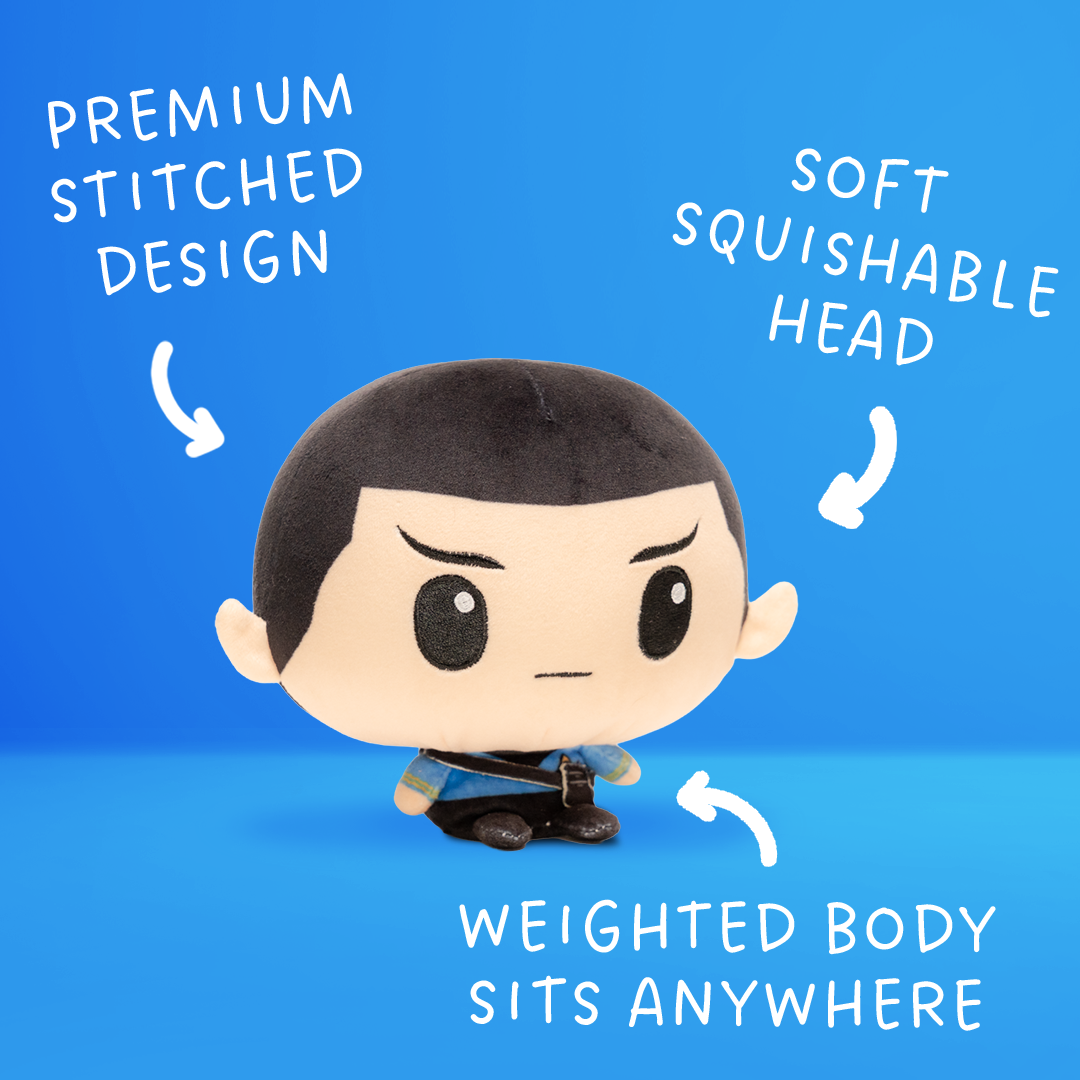 Front view of a Spock plush with short black hair, pointed Vulcan ears, a blue Starfleet uniform, and a small weighted body.