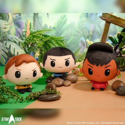 Kirk, Spock, and Uhura Cloudheads plushies sitting near rocks and foliage