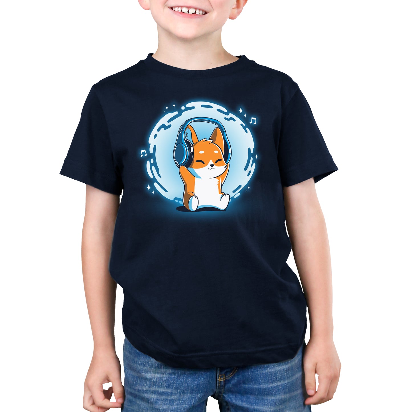 A young boy wearing a Surrounded by Music (GLOW) t-shirt from TeeTurtle, with a corgi on it.