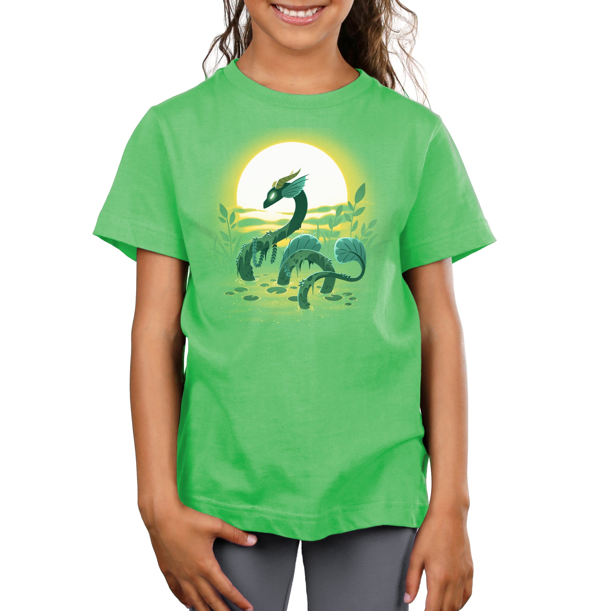 A girl wearing a green Swamp Dragon T-shirt made of Super Soft Ringspun Cotton by TeeTurtle.