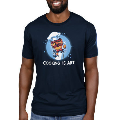 A man wearing an officially licensed Muppets t-shirt that says Swedish Chef: Cooking is Art.