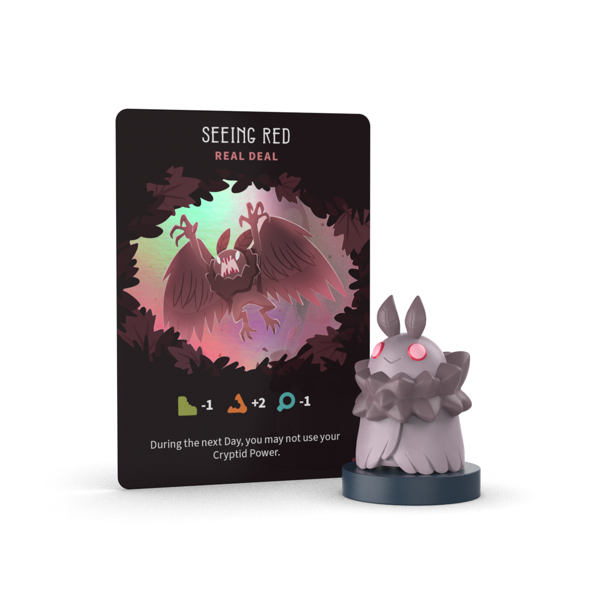 A "Seeing Red: Real Deal" card with stats and restrictions stands beside a small Twisted Cryptids: Vinyl Figure Blind Box by Unstable Games—ideal for collectors who love mystery mini figures.