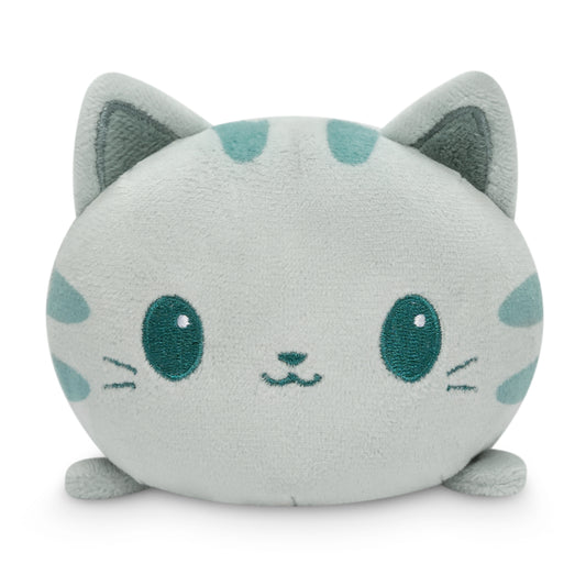 A TeeTurtle Plushiverse Crafty Cat Plushie Tote Bag, a stuffed cat with green eyes, is showcased on a white background.