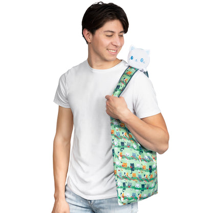 A young man carrying a secret TeeTurtle Plushiverse Meowy Christmas Plushie Tote Bag containing a TeeTurtle plushie inside.