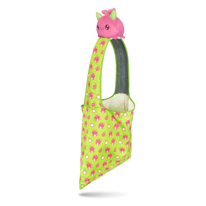 A pink and green polka dot Plushiverse Dragon Fruit Plushie Tote Bag with a plushie pig on it by TeeTurtle.