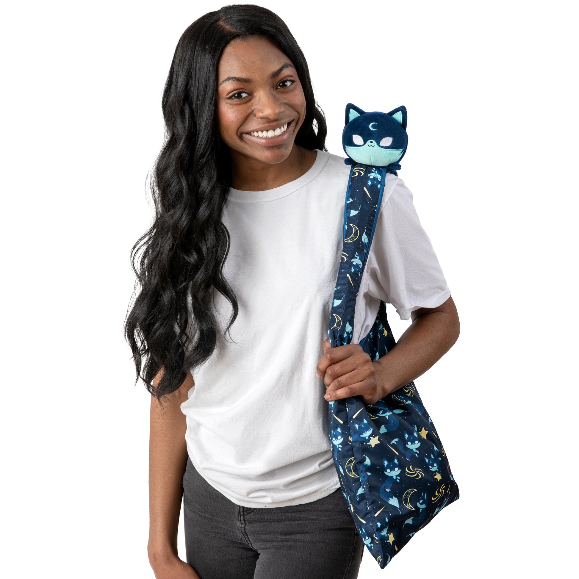 A young woman holding a TeeTurtle Plushiverse Starry Fox Plushie Tote Bag.