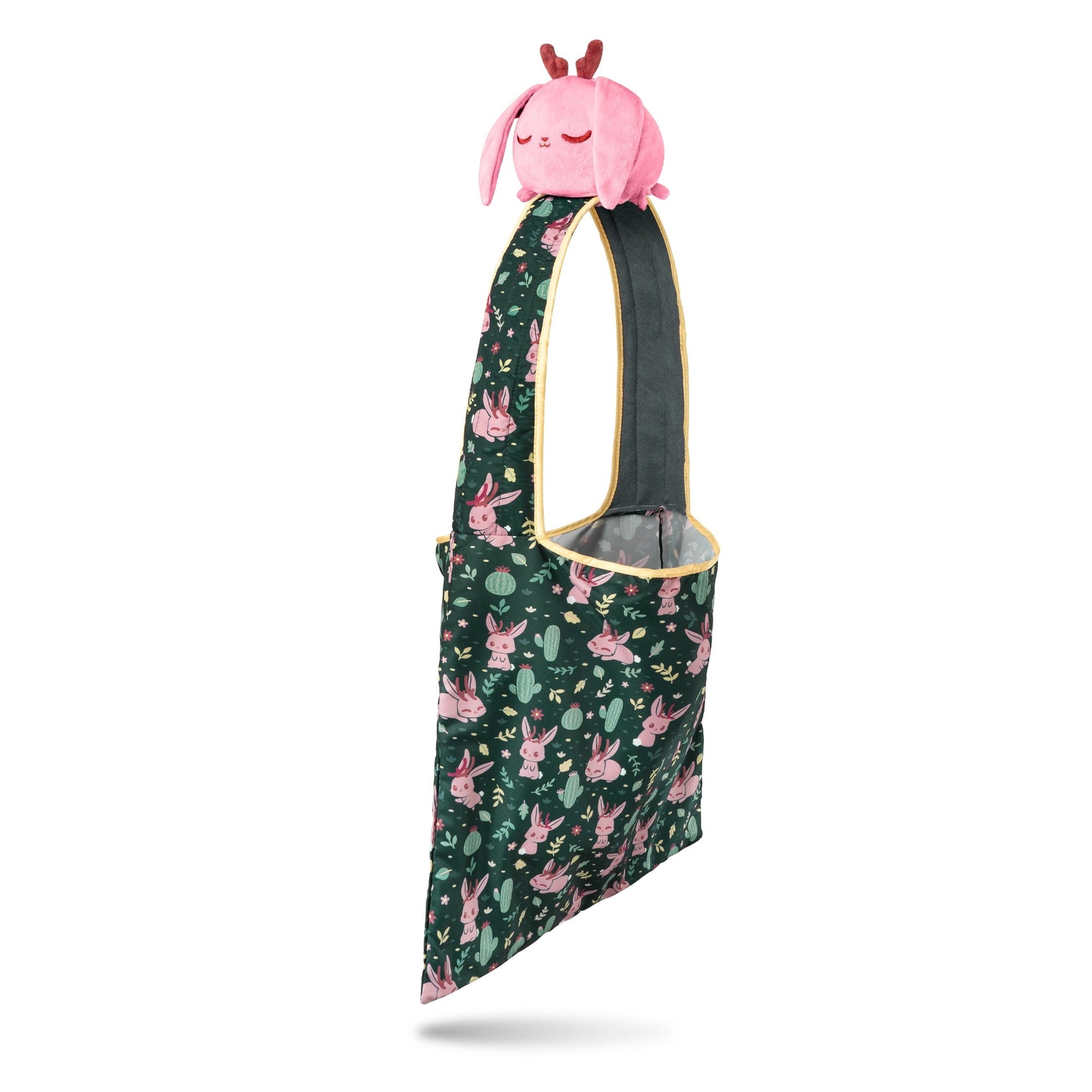 Green floral Plushiverse Fearsome Jackalope Plushie Tote Bag with a plush pink giraffe peeking out, isolated on a white background by TeeTurtle.