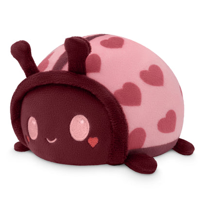 A Plushiverse Lovebug Plushie Tote Bag with hearts on its head, perfect for storing in a velcro storage pouch or tote bag.