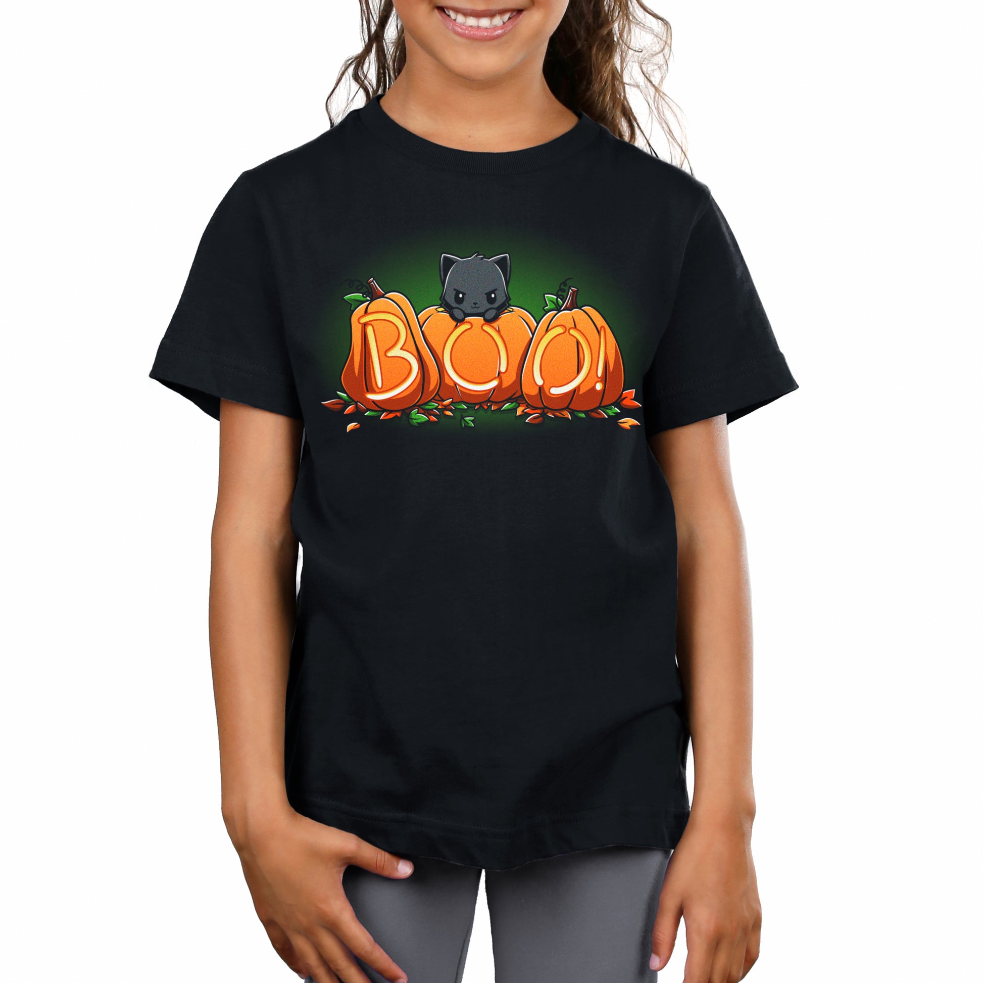 A girl wearing a black Pumpkin Kitty T-shirt from TeeTurtle with the word boo on it during spooky season.