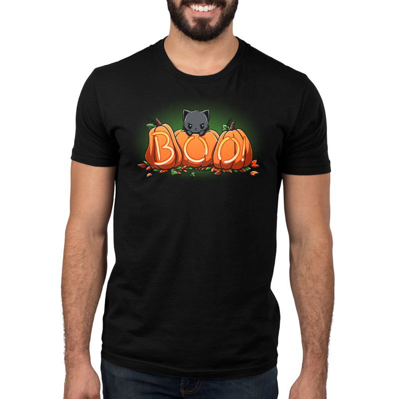 A man wearing a black t-shirt with Pumpkin Kitty pumpkins on it in the fall season, made by TeeTurtle.