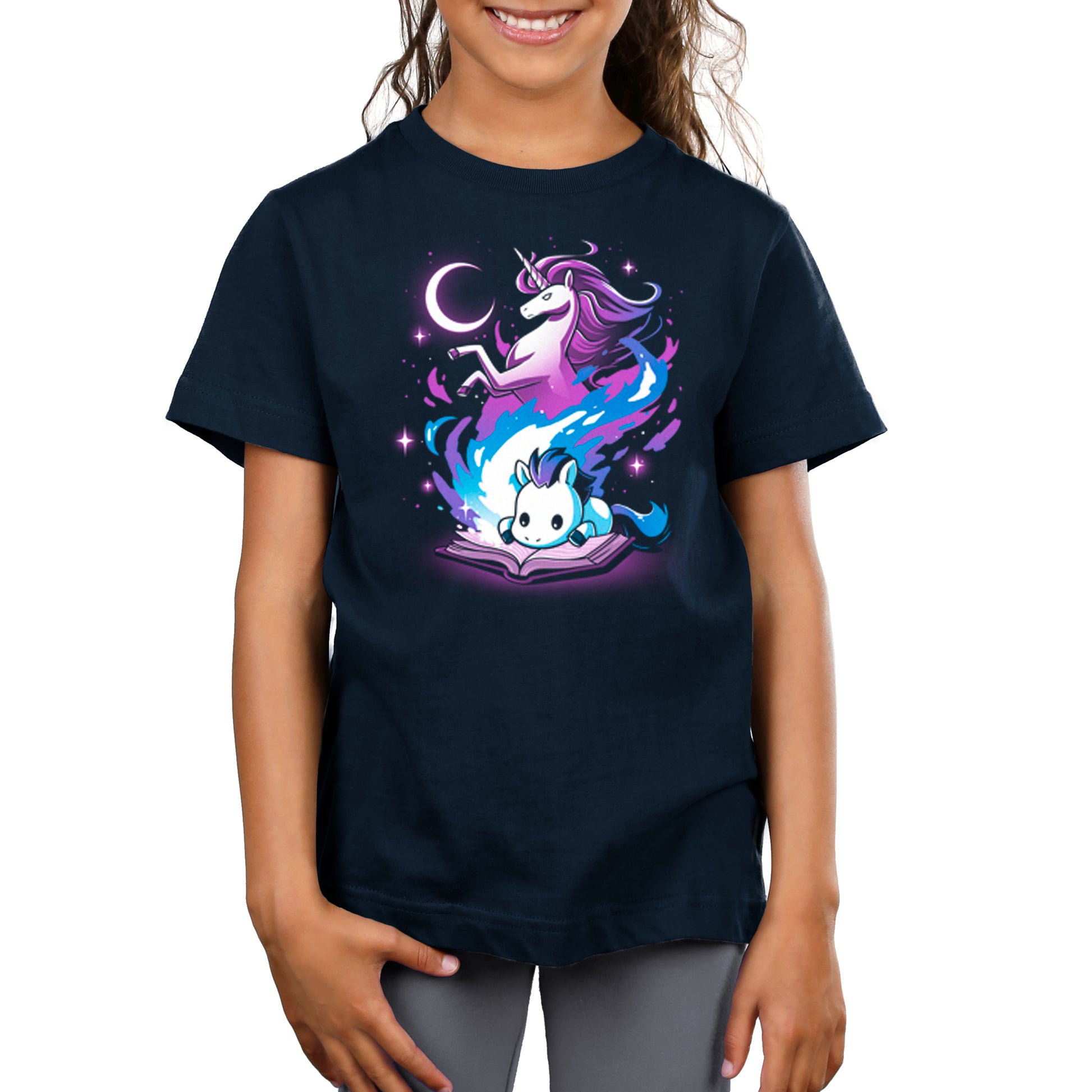 A girl wearing a TeeTurtle A Magical Tale t-shirt with a unicorn on it.