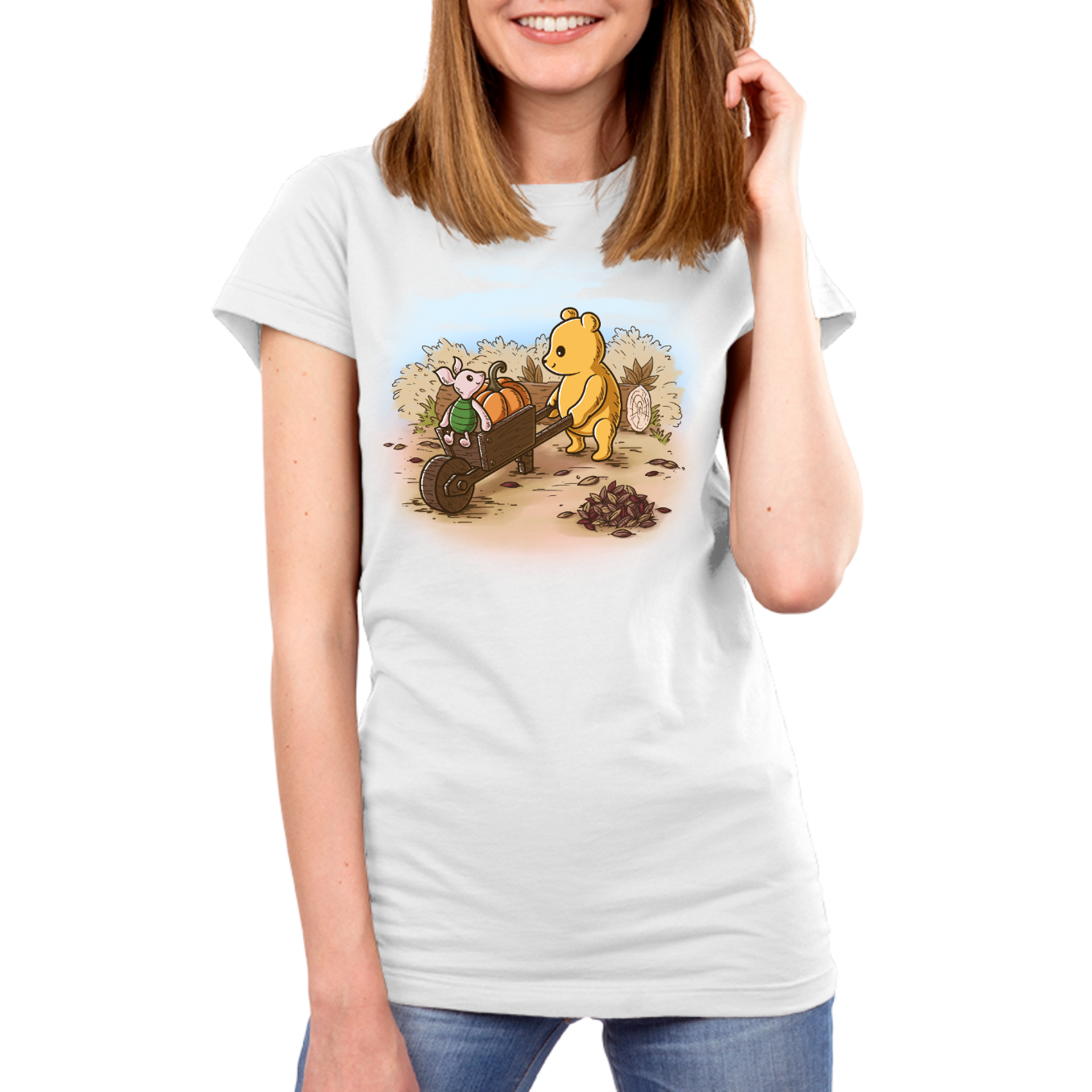 Premium Cotton T-shirt_TeeTurtle white A Perfect Autumn Day Premium Cotton T-shirt featuring a bear pulling a wagon filled with pumpkins while a little mouse rides along, surrounded by autumn bushes, fallen leaves, and tree stumps on a crisp fall day.