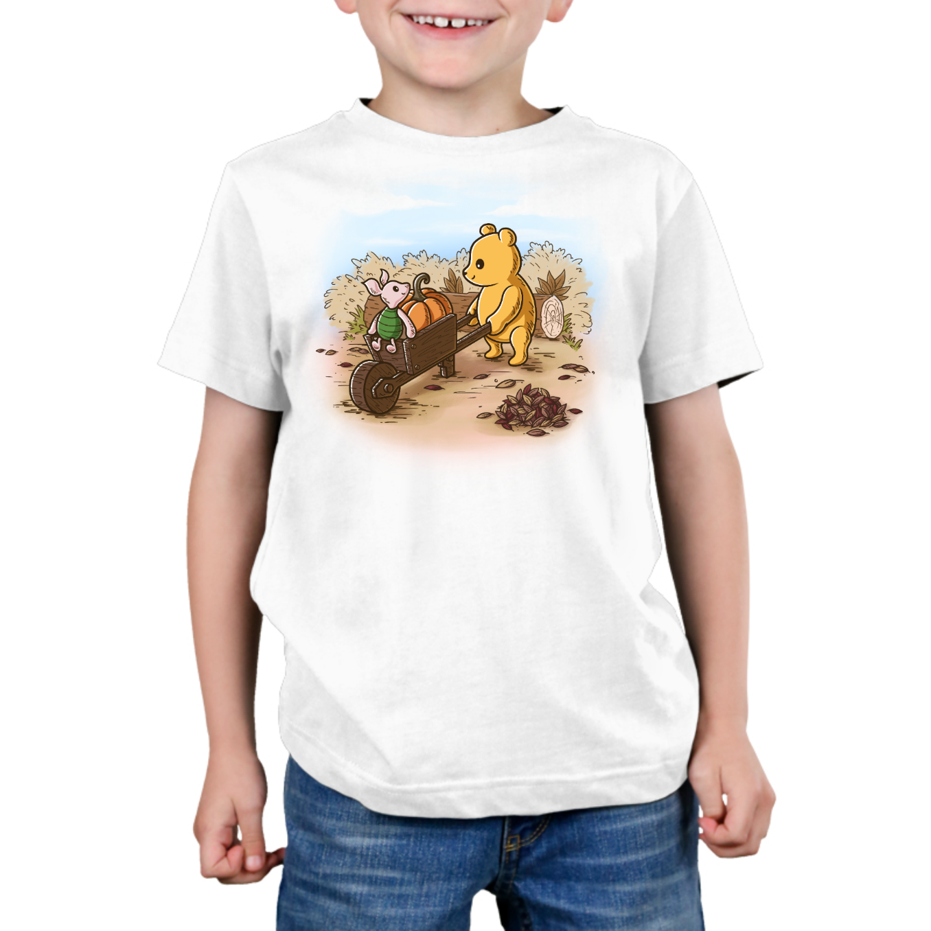 Premium Cotton T-shirt_TeeTurtle white A Perfect Autumn Day Premium Cotton T-shirt featuring a bear pulling a wagon filled with pumpkins while a little mouse rides along, surrounded by autumn bushes, fallen leaves, and tree stumps on a crisp fall day.