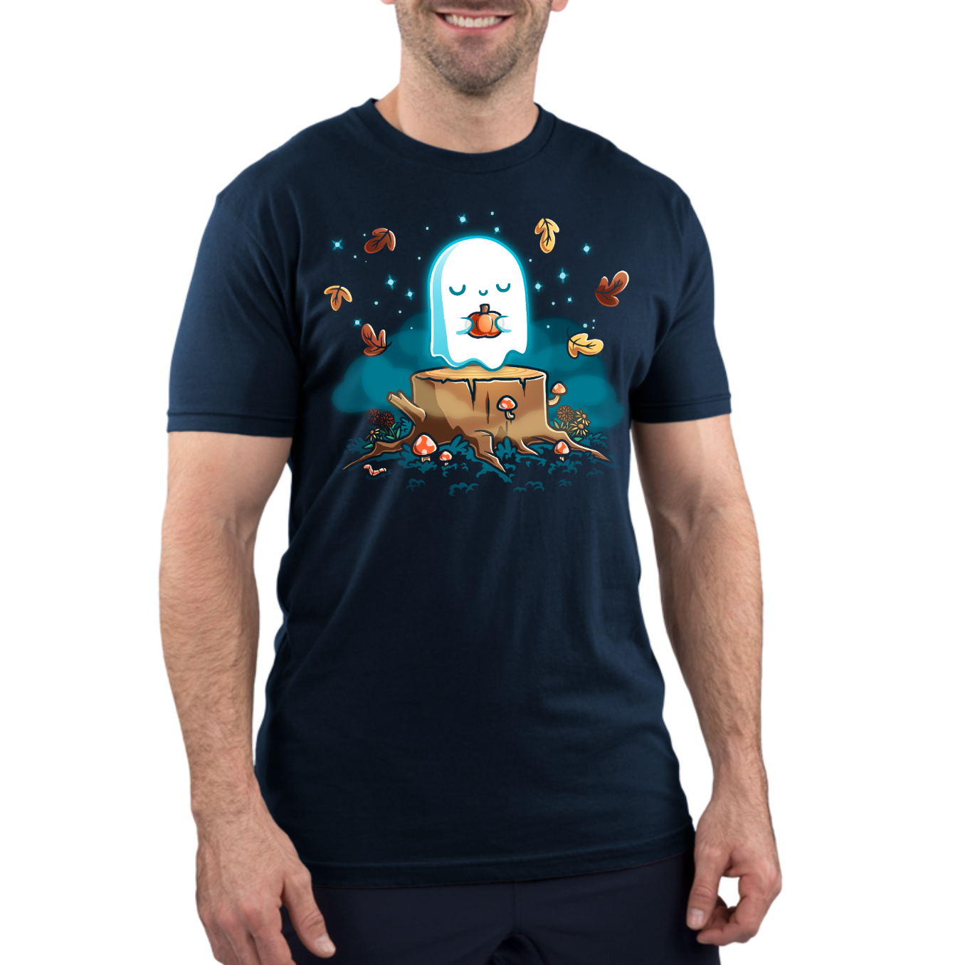 Premium Cotton T-shirt_TeeTurtle navy Autumn Apparition Premium Cotton T-shirt featuring a glowing ghost peacefully holding a pumpkin while floating above a tree stump surrounded by mushrooms, wildflowers, falling autumn leaves, and twinkling stars in a whimsical nighttime forest.