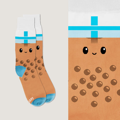 A pair of TeeTurtle Boba Socks with a kawaii face on them.