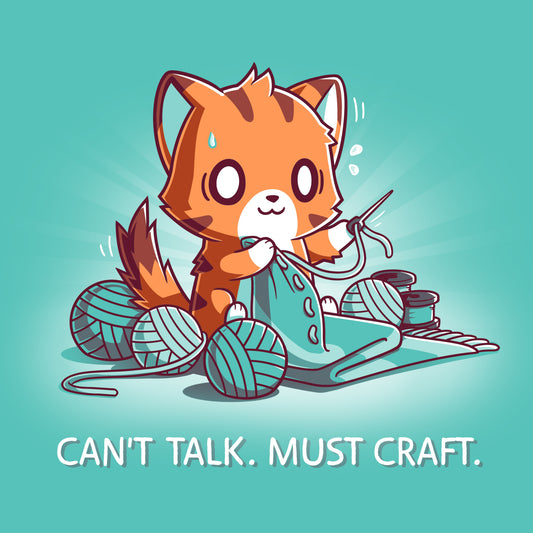 A cartoon fox is knitting with multiple yarn balls around and has a concentrated expression on a Can’t Talk. Must Craft Caribbean blue t-shirt by monsterdigital. Text below reads, 