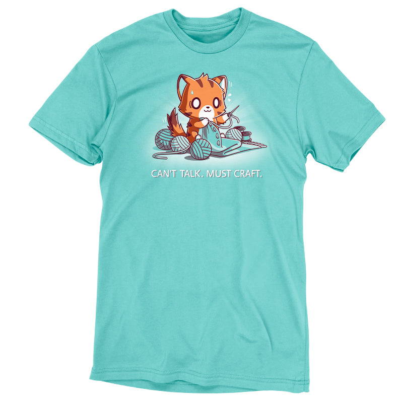 A Caribbean blue T-shirt featuring an illustration of a fox knitting with multiple balls of yarn and the text "Can't Talk. Must Craft." Made from super soft ringspun cotton, this Can’t Talk. Must Craft shirt by monsterdigital ensures comfort while you channel your inner crafter.