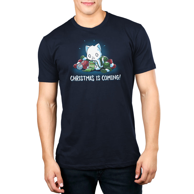 A man wearing a navy blue t-shirt that says "Christmas is Coming!" by TeeTurtle.
