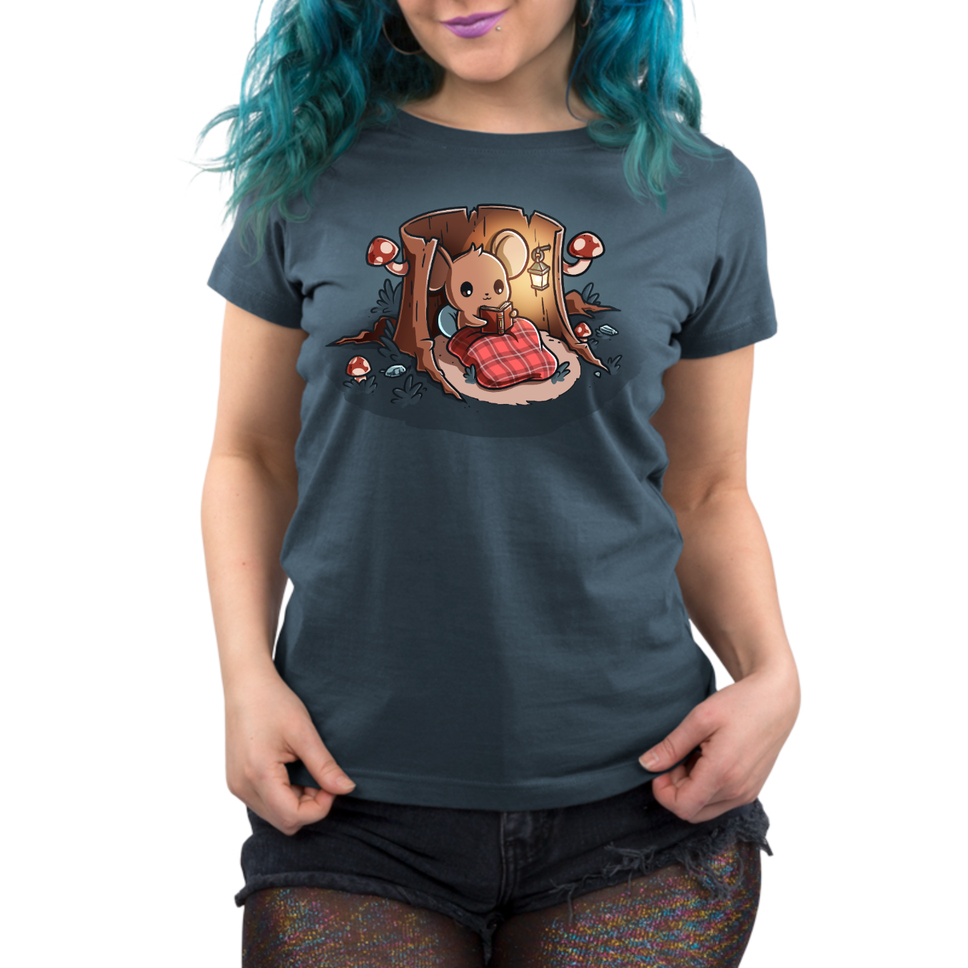 Premium Cotton T-shirt_TeeTurtle heathered blue Cozy Reading Nook Premium Cotton T-shirt featuring a cozy little mouse reading a book under a red plaid blanket inside a hollow tree stump illuminated by a hanging lantern and surrounded by mushrooms.