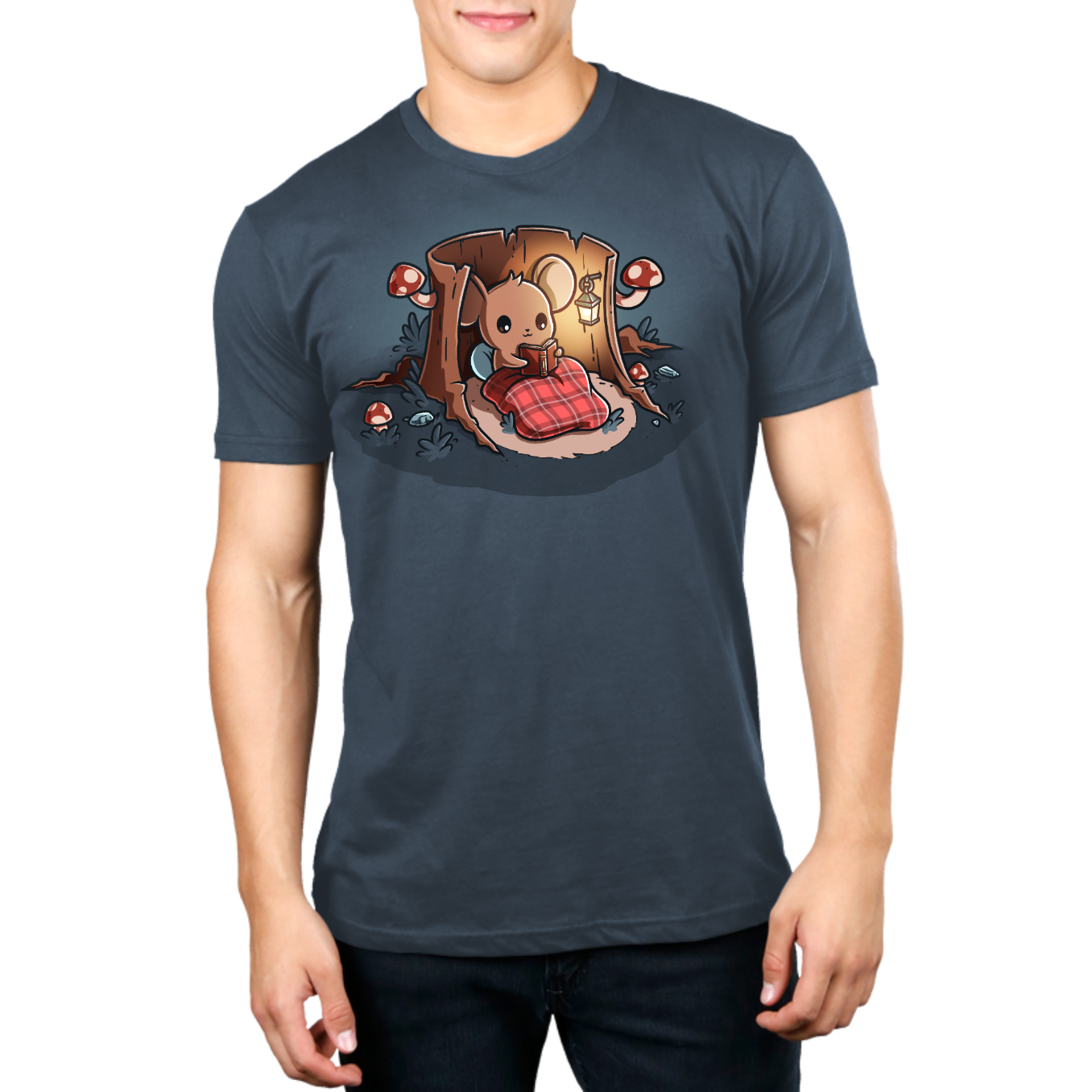 Premium Cotton T-shirt_TeeTurtle heathered blue Cozy Reading Nook Premium Cotton T-shirt featuring a cozy little mouse reading a book under a red plaid blanket inside a hollow tree stump illuminated by a hanging lantern and surrounded by mushrooms.
