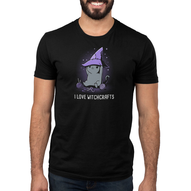 A man wearing a black Crafty Kitty t-shirt by TeeTurtle featuring the phrase "I Love Witches" shows his admiration for witchcraft.