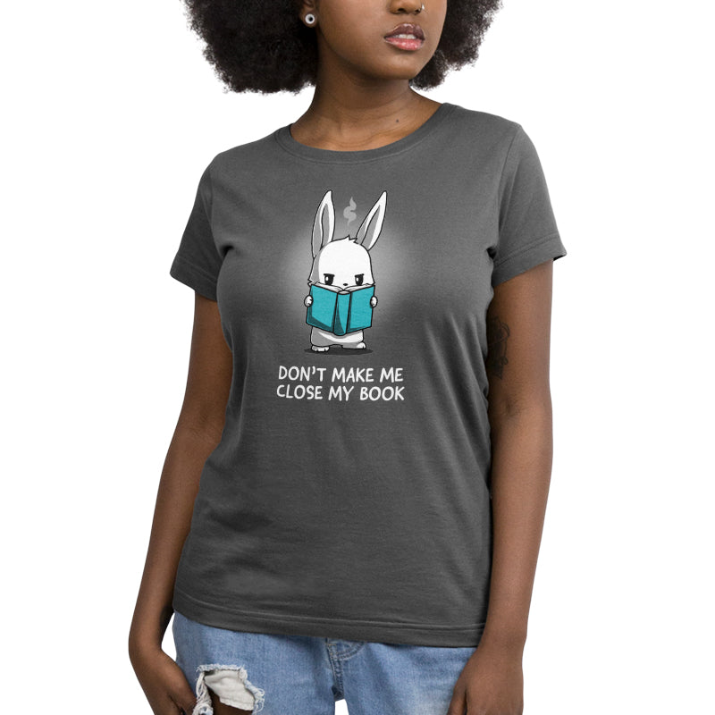 A woman wearing a TeeTurtle t-shirt that says "Don't Make Me Close My Book" during reading time.